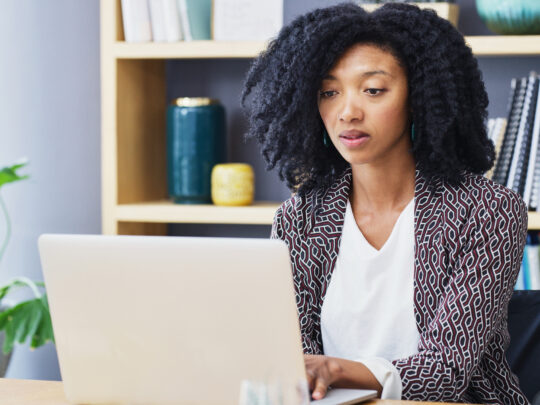 A woman works on a computer.